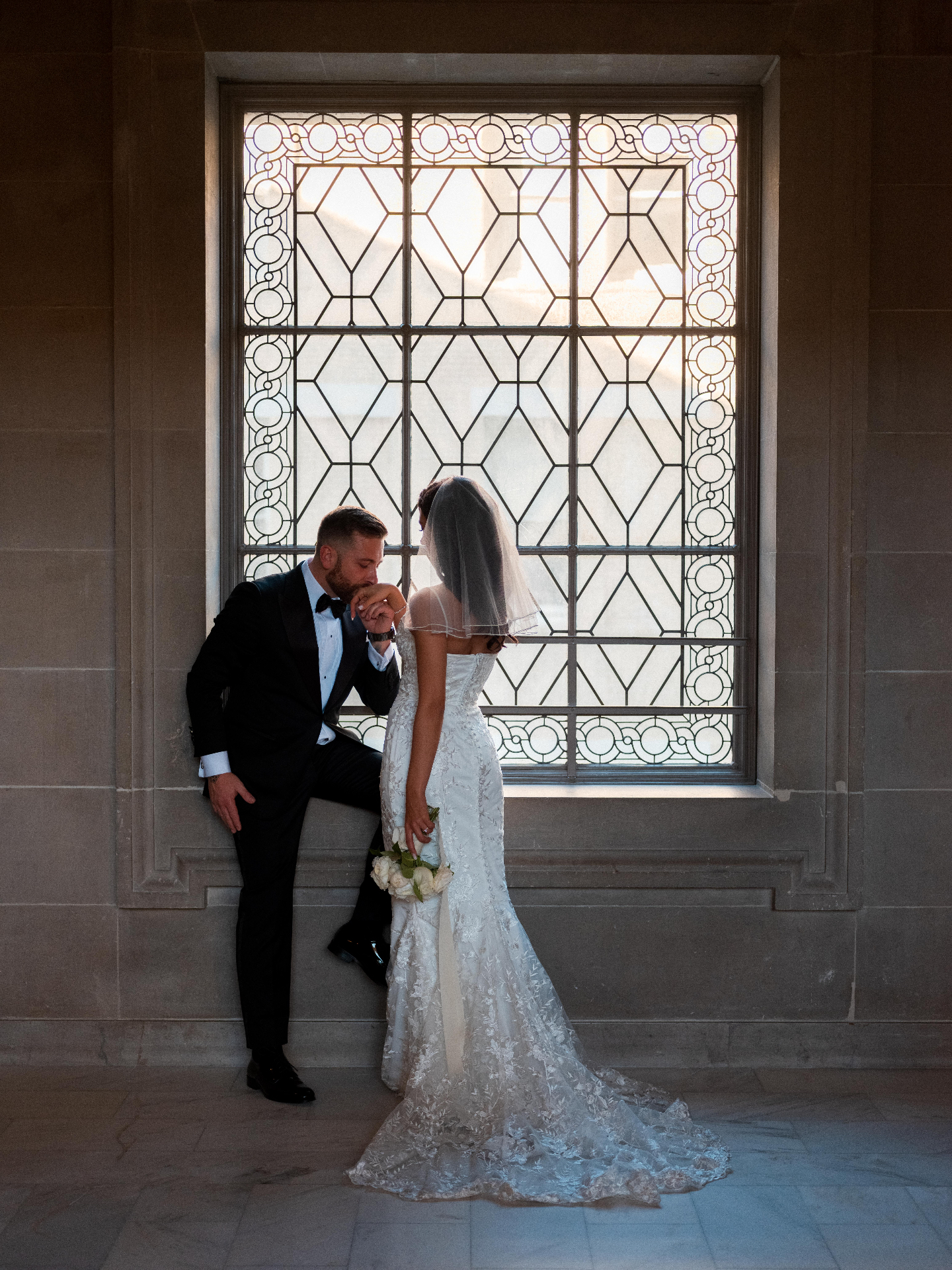 a kiss on the hand, city hall — documentary wedding photograph by Norah Joy, Bay Area wedding photographer