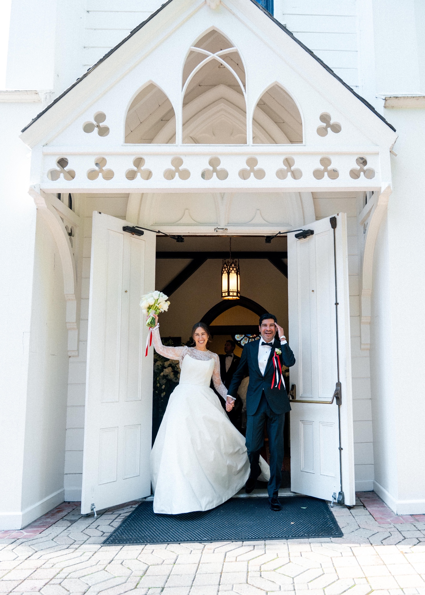 a joyful exit, beneath the chapel doors — documentary wedding photograph by Norah Joy, Bay Area wedding photographer